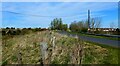 The minor road rises to cross the bridge over the A77