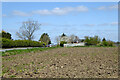 Ploughed field and Hillside Cottage