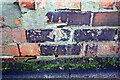 Benchmark on brick wall on south side of Victoria Place