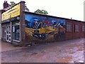 Building Supplies shop with mural on side wall