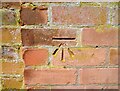 Benchmark on brick wall pier on west side of Mill Lane