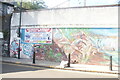 View of street art on the wall of Bethnal Green Motor Works from Three Colts Lane