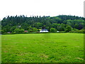 View across a meadow to a half-timbered house near Pontesbury