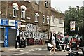 View of street art on the side of a Lycamobile mobile phone repair centre on Viaduct Street from Bethnal Green Road