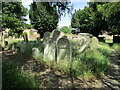TL1791 : The churchyard, Yaxley by Jonathan Thacker