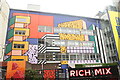 View of Camille Walala street art on the rear of Rich Mix from Redchurch Street