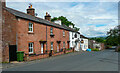 View along the B6413 past houses and the Joiners Arms, Lazonby