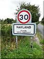 TL9734 : Nayland Village Name sign by Geographer