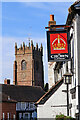 Pub sign with church tower in Claverley