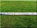 Covid-19 precautionary sign on Sports Field railing, Westfield