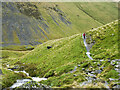 NY3328 : Mountain walker on path approaching Scales Beck by Trevor Littlewood