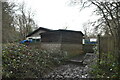 Building by footpath in High Castle Wood