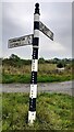 Cumberland County Council finger signpost on grass island NW of Cotehill