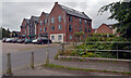 Shops seen from the bridge over the stream by Riverside Close, Scarning