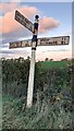 Leaning Cumberland County Council signpost at junction near Bankdale Farm