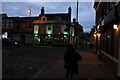 View of The Shamrock lighting up at dusk