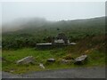 Stone marker at the foot of Twmbarlwm, shrouded in rain cloud