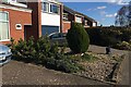 SP3368 : Conifers, front garden, Windmill Hill, Cubbington by Robin Stott