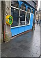 Yellow and green box on a High Street wall, Newport