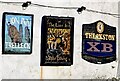 Three nameboards on a wall of the Lion Inn, Trellech, Monmouthshire