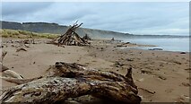 NO7463 : Driftwood pyramids at St Cyrus beach by Gordon Brown