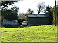 Grassy area with old car and caravan