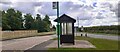 Bus stop with shelter at East Leake village name signs