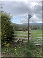 Stile and bridleway sign at Pont y Blodau