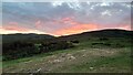 NH6791 : Sunset behind Cnoc Dubh Beag by Alastair Harkiss