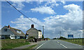 Houses and sign for caravan park on the A487, looking east