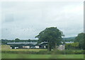 J2084 : Farm west of Templepatrick, seen from a train by Colin Pyle
