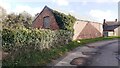 Farm building on NE side of rural road in Holme Gate