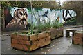 TQ3674 : Planters and wildlife mural at Buckthorne Bridge by David Martin