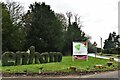 Enham Alamein: Topiary sign and the A343 through the village