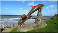 Leaping dolphin sculpture at Aberporth Bay