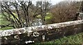 View of Quarry Beck over north parapet of New Mills Bridge