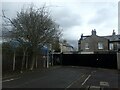 A street of houses beyond a gate