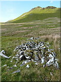 SH7147 : Unidentified pile of stones on the bank of a stream by Richard Law