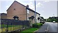 West end of cemetery boundary wall and Nos. 2 & 3 Hadrians Rise on south side of B6322