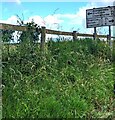 Directions and distances sign on a bank above the B4347 in rural Monmouthshire