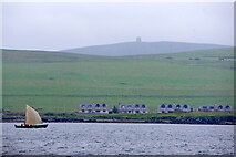 HU4941 : Houses at Voeside, Bressay with passing boat by Mike Pennington