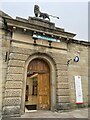 Entrance to Glossop Post Office with lion Statue