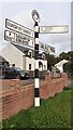 Cumberland County Council finger signpost on north side of B5307 outside Holme Garth