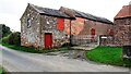 NY3457 : Farm buildings on NW side of road at Hosket Hill by Luke Shaw