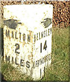 Old Milestone, on the B1257, 60m E of East Street; opposite Cherry Tree Cottage,