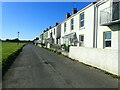 A row of semi-detached houses facing the beach at Llansteffan