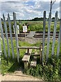 SJ7854 : Wooden step stile in metal railway lineside fencing by Jonathan Hutchins