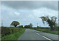 Stone memorial ahead on the right of the A3052