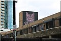 View of cat street art above the warehouses on Bethnal Green Road from Ebor Street