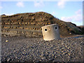 Cliff and concrete pillbox at Kimmeridge Bay beach